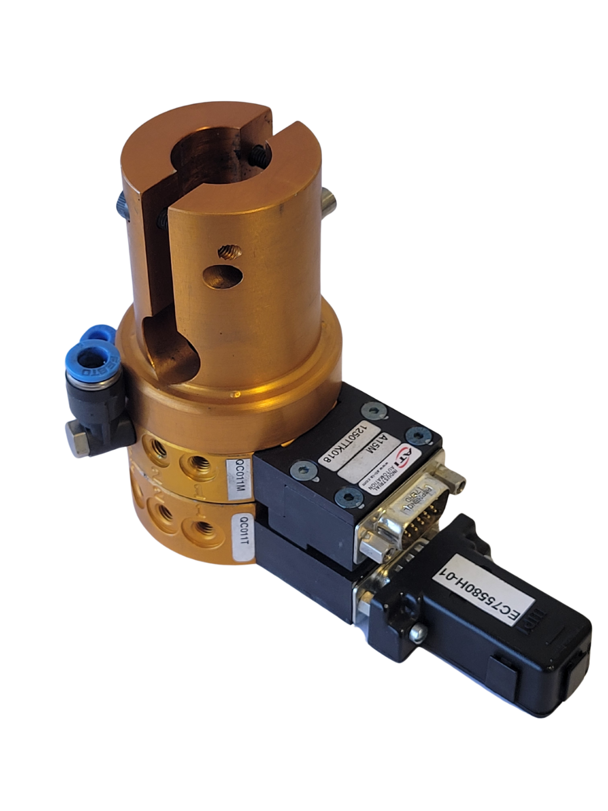 Mechanical component with gold cylindrical part and black electronic module on a white background