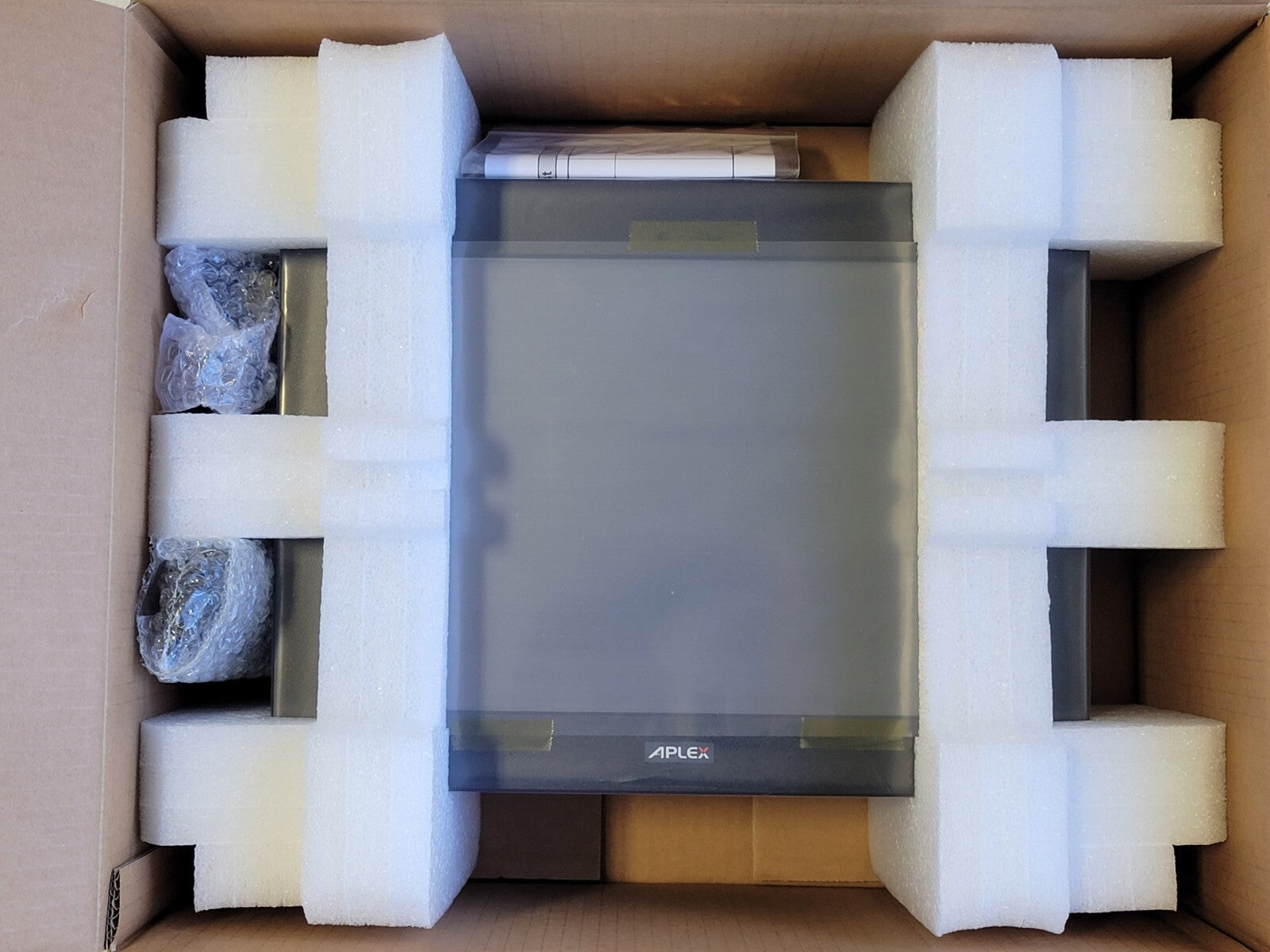 Electronic device in packaging with foam inserts