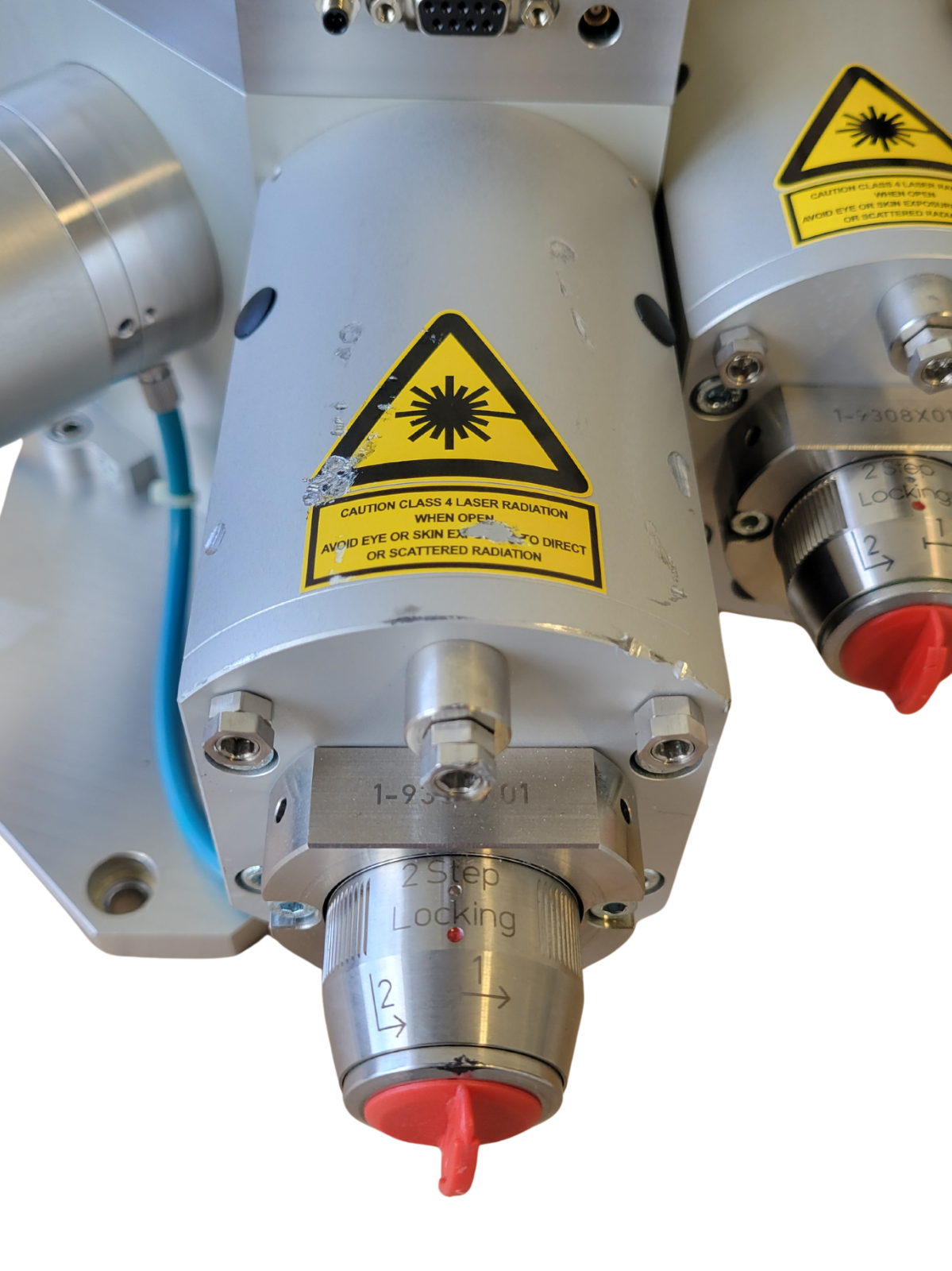 Industrial machine component with warning labels on a white background