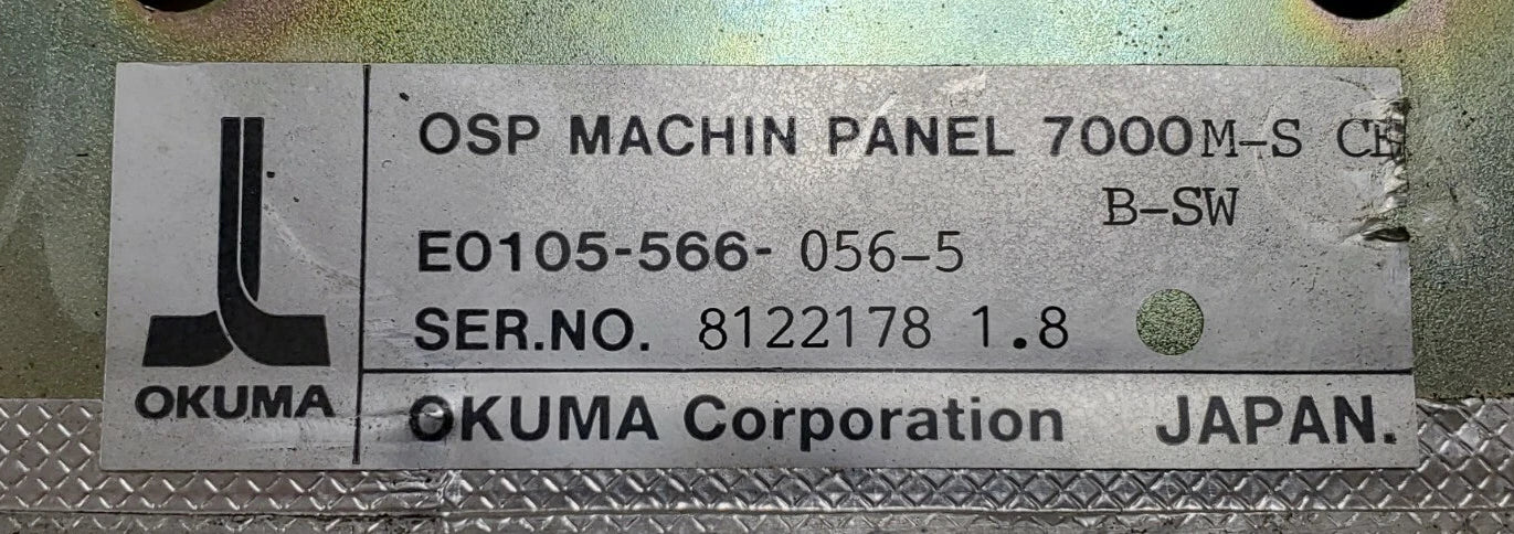 Metallic label with 'OKUMA' branding and technical specifications on a textured background