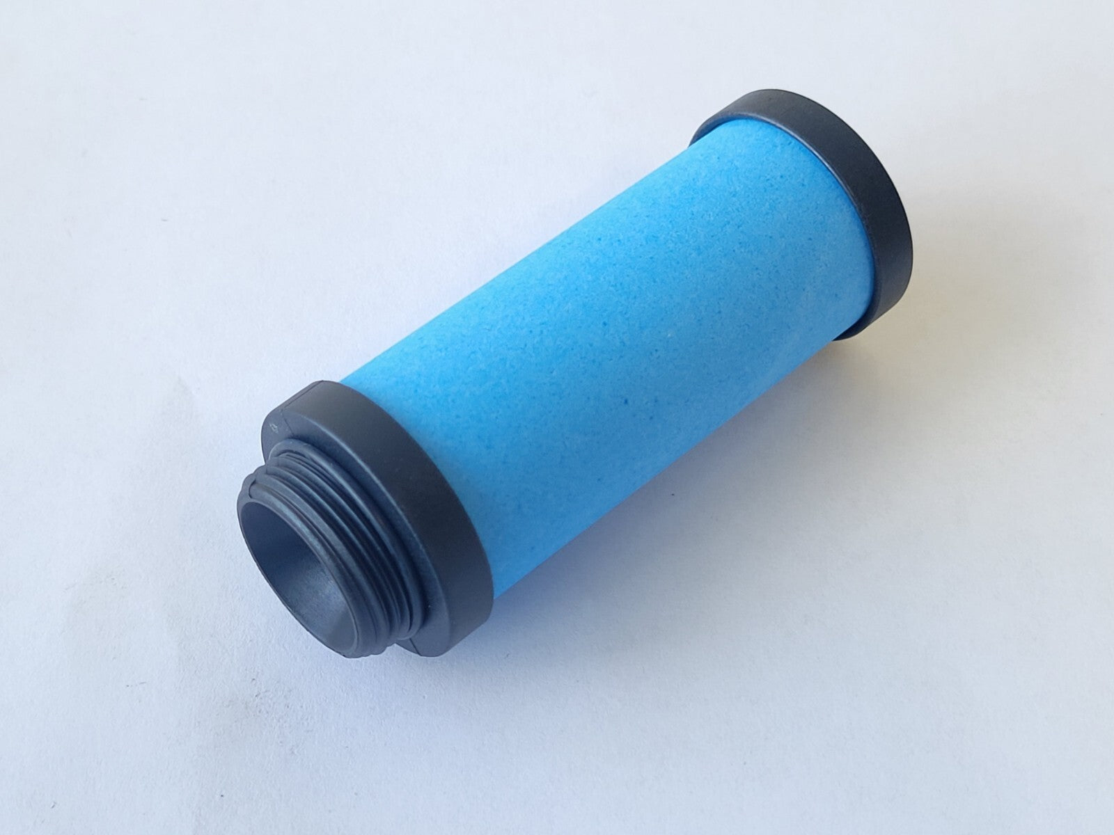 Blue filter cartridge with black ends on a white background