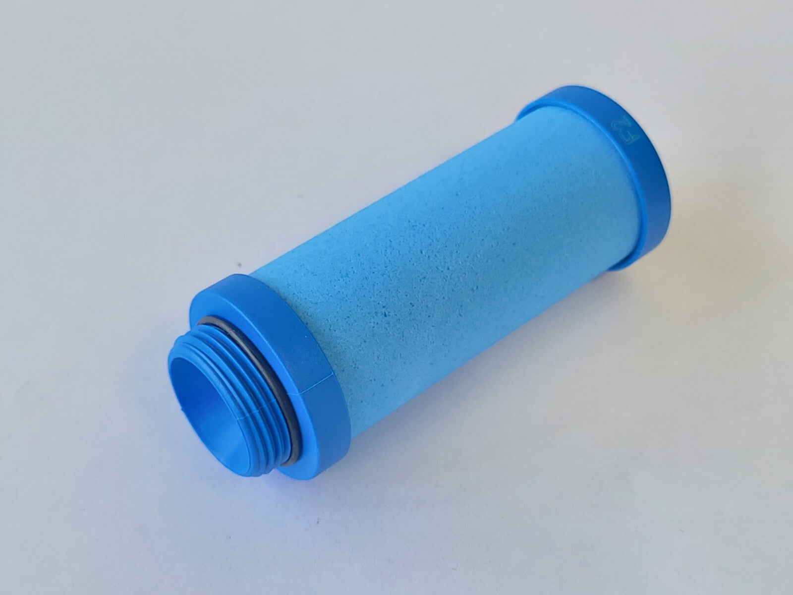 Blue cylindrical filter on a white background