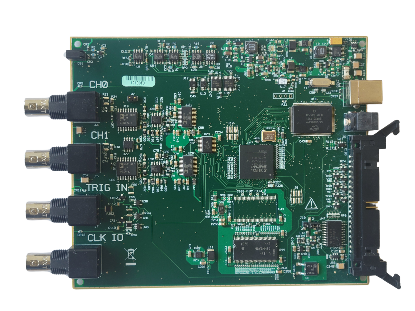 Green electronic circuit board with various components on a white background