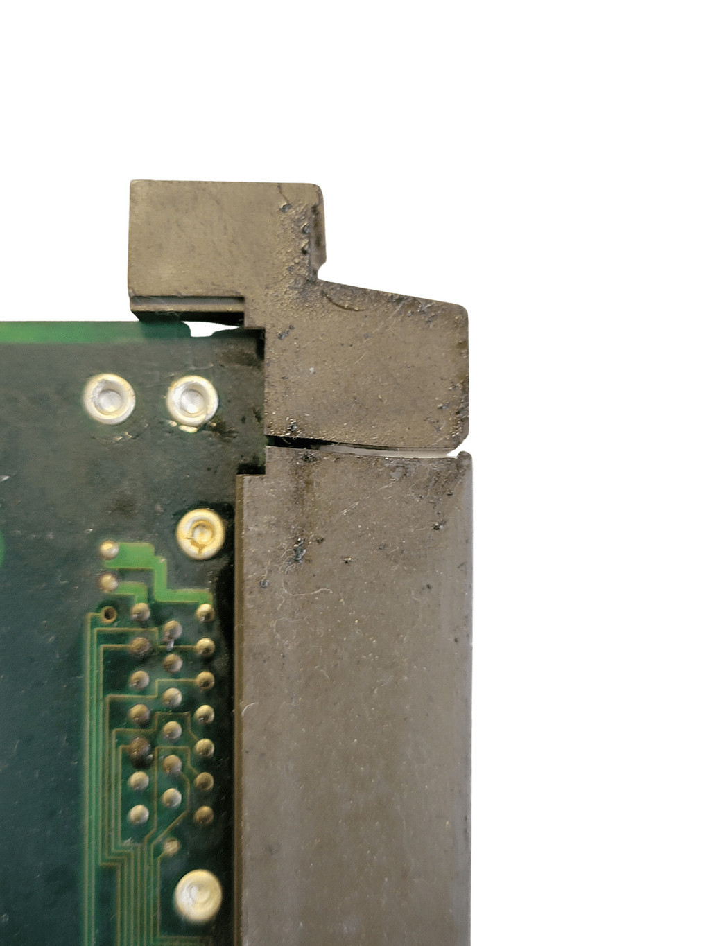 Close-up of a metal component and printed circuit board on a white background