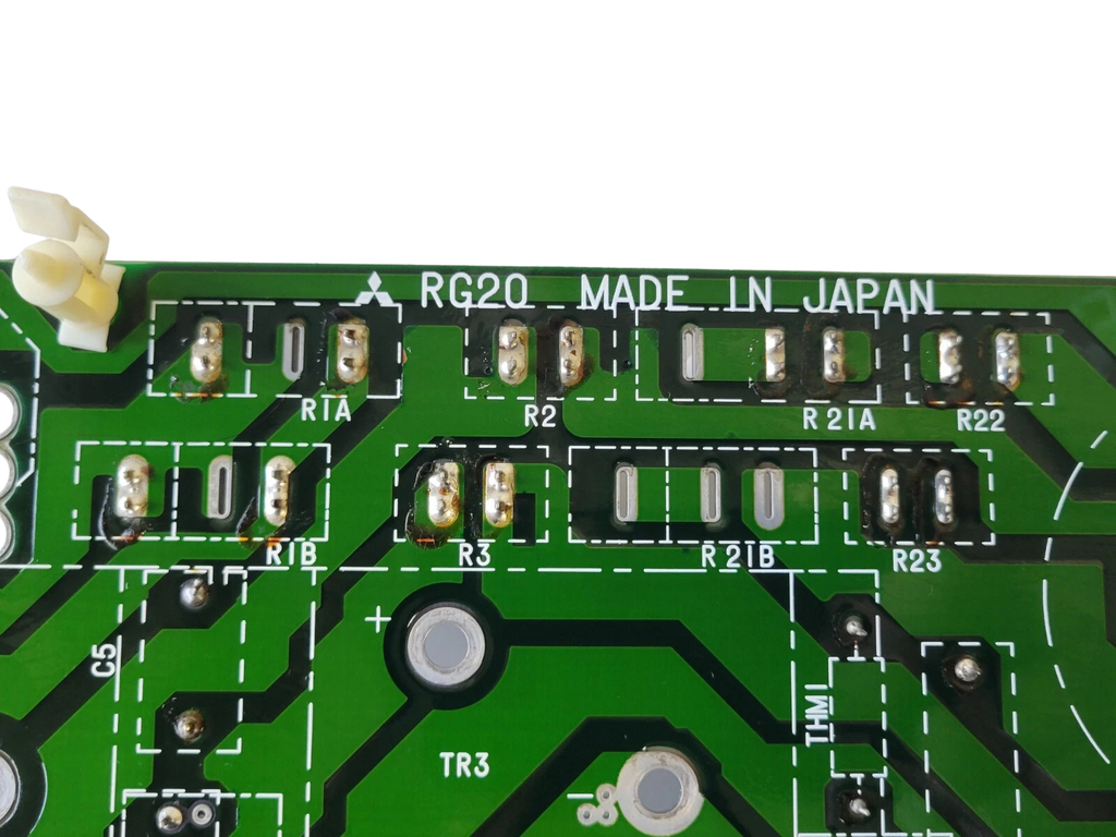 Close-up of a green printed circuit board with various components and 'MADE IN JAPAN' text.