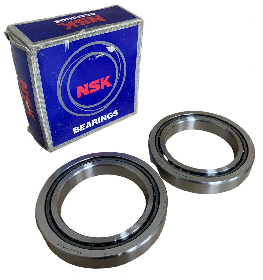 Two metal bearings with an NSK branded box on a white background