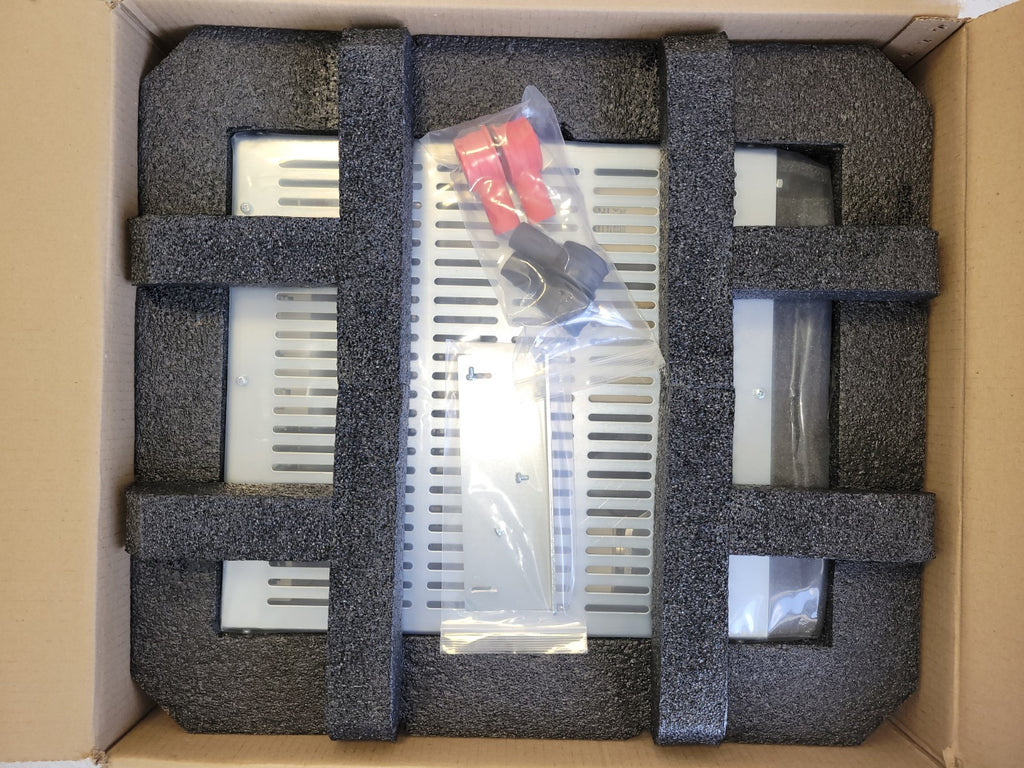 Electronic device in packaging with foam inserts on a cardboard surface