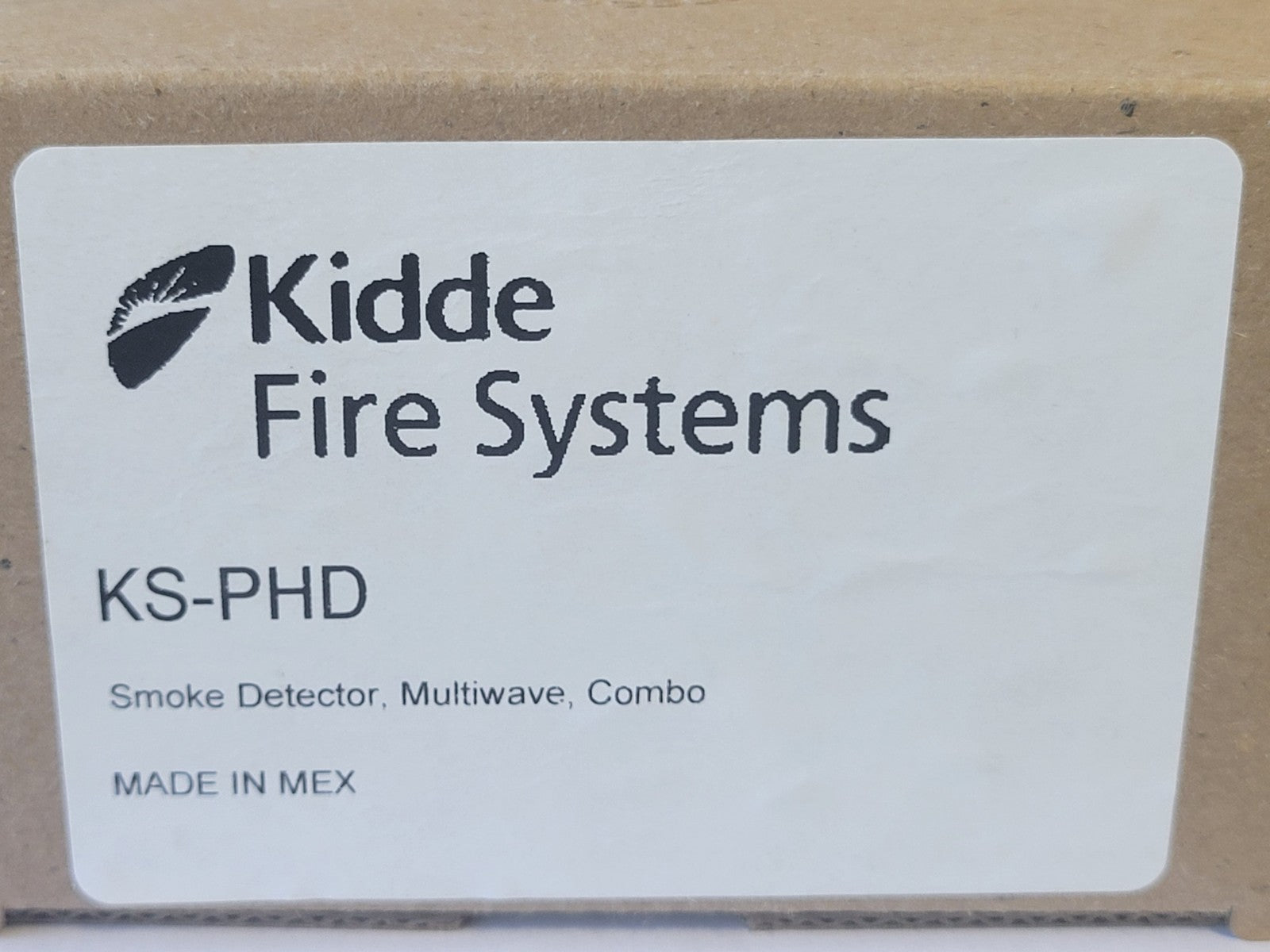 Label for Kidde Fire Systems smoke detector on a cardboard background